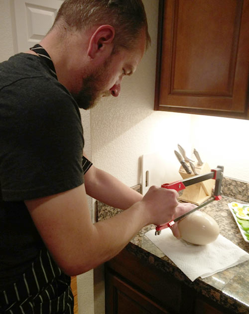 Cutting a hard-boiled ostrich egg with a hacksaw (Photo credit: Dave)