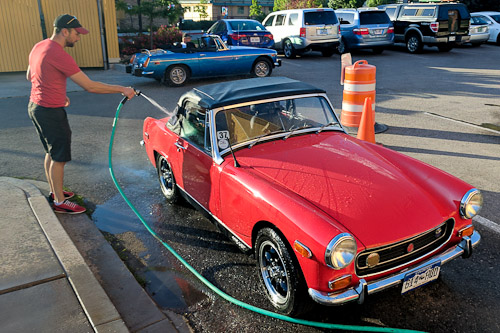 Rosie the MG Midget gets a bath from Tyler after enduring a lost alternator nut