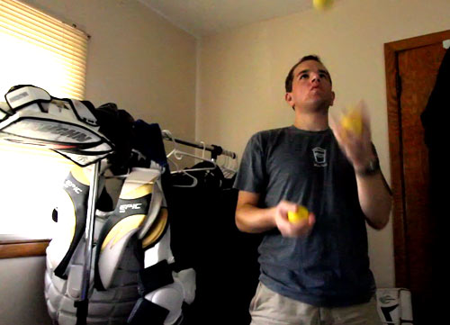 Juggling lacrosse balls with my goalie gear in the background